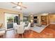 Cozy living room with a fireplace and dining area with sliding glass doors to the deck at 150 Northchase Dr, Concord, NC 28027