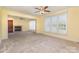 Open living room boasts a fireplace, large window for natural light, and neutral carpet at 150 Northchase Dr, Concord, NC 28027