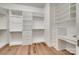 Custom walk-in closet featuring built-in shelving and drawers, and a dedicated vanity area at 15927 Vale Ridge Dr, Charlotte, NC 28278