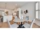 Stylish dining area open to the kitchen, with hardwood floors and seating for four at 15927 Vale Ridge Dr, Charlotte, NC 28278