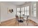 Bright dining area with large windows, hardwood floors, and seating for four at 15927 Vale Ridge Dr, Charlotte, NC 28278
