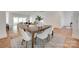 Stylish dining room with a wooden table, seating for four, and seamless access to the living area at 15927 Vale Ridge Dr, Charlotte, NC 28278
