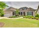 Beautiful brick home featuring a lush front yard with mature landscaping and an attached two-car garage at 15927 Vale Ridge Dr, Charlotte, NC 28278