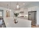 Modern kitchen with stainless steel appliances, quartz countertops, and ample cabinet space at 15927 Vale Ridge Dr, Charlotte, NC 28278