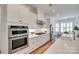 Modern kitchen featuring stainless steel appliances, white cabinets, and quartz countertops at 15927 Vale Ridge Dr, Charlotte, NC 28278