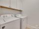 Functional laundry room area with ample cabinet storage and side by side washer and dryer at 15927 Vale Ridge Dr, Charlotte, NC 28278