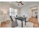 Bright home office featuring a ceiling fan, wood flooring, and a comfortable seating area at 15927 Vale Ridge Dr, Charlotte, NC 28278