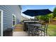 Cozy backyard with hot tub, umbrella table, and stairs leading to upper level at 1620 Callahan Rd, Fort Mill, SC 29715