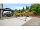 Spacious backyard with a covered patio, a fire pit, and ping pong and basketball equipment at 1620 Callahan Rd, Fort Mill, SC 29715