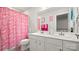 Charming bathroom featuring double sinks, plenty of counter space, and a fun Barbie-themed shower curtain at 1620 Callahan Rd, Fort Mill, SC 29715