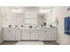 Bright bathroom featuring double sinks with a window providing natural light, and a pristine white aesthetic at 1620 Callahan Rd, Fort Mill, SC 29715