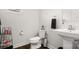 A clean half-bathroom with a pedestal sink, toilet, and modern fixtures at 1620 Callahan Rd, Fort Mill, SC 29715