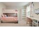 Bright ' bedroom featuring a white bunk bed, pink bedding, a shelving unit and a desk at 1620 Callahan Rd, Fort Mill, SC 29715