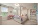 Bright ' bedroom with 4-poster bed, pink desk with white chair, and decorative heart mirror at 1620 Callahan Rd, Fort Mill, SC 29715