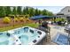 Spacious backyard featuring a hot tub, outdoor table, and covered seating area at 1620 Callahan Rd, Fort Mill, SC 29715