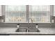 Close-up of the kitchen sink with granite countertops and white cabinets at 1620 Callahan Rd, Fort Mill, SC 29715