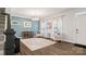 Bright living room featuring wood floors, neutral walls, light furniture, and a modern chandelier at 1620 Callahan Rd, Fort Mill, SC 29715