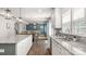 Open concept kitchen with a view of the living room with a dining table and chairs and cozy couches at 1620 Callahan Rd, Fort Mill, SC 29715