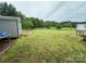 Expansive backyard featuring a shed, deck, and green space, perfect for outdoor activities at 181 Trivette Rd, Harmony, NC 28634