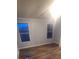 Bright bedroom featuring wood-look flooring and two windows at 181 Trivette Rd, Harmony, NC 28634