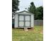 Storage shed with double doors and ramp situated in a spacious grassy backyard at 181 Trivette Rd, Harmony, NC 28634