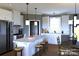 Bright kitchen features a large island with seating, white cabinetry, modern appliances, and stylish pendant lighting at 1821 Country Club Rd, Wadesboro, NC 28170