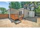 View of home's back exterior, featuring new deck and additional storage unit at 1829 Jennings St, Charlotte, NC 28216