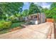 Charming single-story home with a welcoming front porch and a spacious driveway, surrounded by lush greenery at 1829 Jennings St, Charlotte, NC 28216