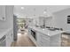 Open floorplan of the Kitchen into the living space, with stainless steel appliances and a large center island at 1829 Jennings St, Charlotte, NC 28216