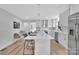 Bright, modern kitchen with a large island, stainless steel appliances, white cabinetry, and stylish pendant lighting at 1829 Jennings St, Charlotte, NC 28216