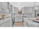 Modern kitchen design featuring sleek white cabinetry, stainless steel appliances, and an induction cooktop at 1829 Jennings St, Charlotte, NC 28216