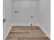 Empty laundry room featuring new flooring and utility connections at 1829 Jennings St, Charlotte, NC 28216