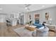 Bright open-plan living room with a modern kitchen, blue sofa, light wood floors and minimalist decor at 1829 Jennings St, Charlotte, NC 28216