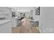 Open-concept living space with an island kitchen, stylish bar stools, and a cozy sitting area at 1829 Jennings St, Charlotte, NC 28216