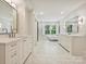 Luxurious bathroom with dual vanities, marble countertops, and a freestanding tub at 1915 Winthrop Ave, Charlotte, NC 28203
