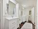 Bright bathroom featuring double vanities, cabinet with mirrors, and neutral rug on dark hardwood floor at 1915 Winthrop Ave, Charlotte, NC 28203
