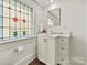 Charming bathroom with a unique stained glass window and modern fixtures at 1915 Winthrop Ave, Charlotte, NC 28203