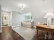 Bright bedroom featuring a daybed, a window, hardwood floors, and adjacent bath with vanity at 1915 Winthrop Ave, Charlotte, NC 28203
