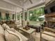 Covered patio featuring stone fireplace, ceiling fan, and comfortable seating area overlooking backyard at 1915 Winthrop Ave, Charlotte, NC 28203