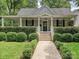 Charming craftsman home with a covered front porch and well-manicured landscaping at 1915 Winthrop Ave, Charlotte, NC 28203