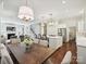 Open concept kitchen and dining area with modern lighting and stainless steel appliances at 1915 Winthrop Ave, Charlotte, NC 28203