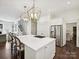 White kitchen island featuring gas cooktop, quartz countertops, and pendant lighting at 1915 Winthrop Ave, Charlotte, NC 28203