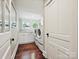 Bright laundry room with hardwood floors, front-loading washer and dryer, and counter space at 1915 Winthrop Ave, Charlotte, NC 28203