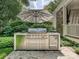 Outdoor kitchen featuring stainless steel grill and mini-refrigerator on stone patio at 1915 Winthrop Ave, Charlotte, NC 28203