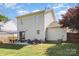 Spacious backyard with patio seating, a fire pit, lush grass, and privacy fencing at 197 Devon Forest Dr, Mooresville, NC 28115
