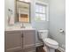 Charming bathroom with a gray vanity, mirror, and neutral paint at 197 Devon Forest Dr, Mooresville, NC 28115