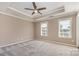 Inviting bedroom with tray ceiling, ceiling fan, and ample natural light from two windows at 197 Devon Forest Dr, Mooresville, NC 28115