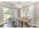 Bright dining room with wood floors, modern lighting, and sliding glass doors to the outdoor patio at 197 Devon Forest Dr, Mooresville, NC 28115