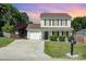 Charming two-story home with manicured lawn, mature landscaping, and a welcoming front porch at 197 Devon Forest Dr, Mooresville, NC 28115