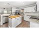 Spacious kitchen with stainless steel appliances, wooden island, and granite countertops at 197 Devon Forest Dr, Mooresville, NC 28115